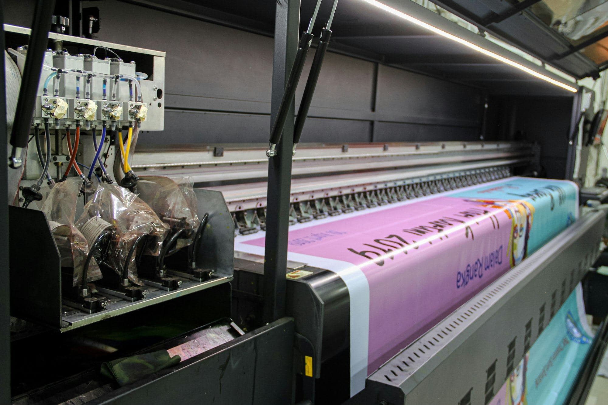 A large-format printer printing a banner